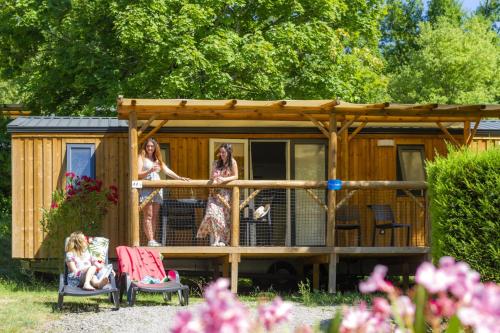 a group of women standing on the balcony of a house at Camping Capfun La Bretèche in Les Épesses