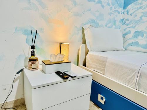 a bedroom with a bed and a night stand with a remote control at Sina Rent Room in Rome