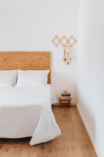 a bedroom with a large bed and a table at Chão do Ribeirinho Country House in Atalaia