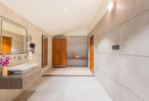 a bathroom with a sink and a mirror at The Forest Chapter by Sayaji Madhai in Sohāgpur