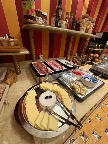 a table topped with cheese and other food items at La Villa Royale in Paris