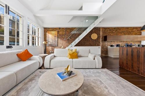 a living room with a couch and a table at The Marylebone Villa in London