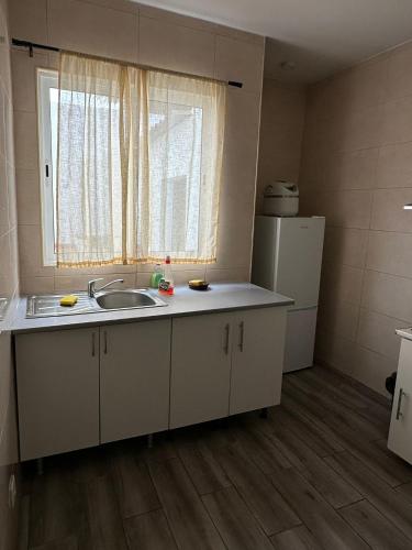 a small kitchen with a sink and a window at Micaelense Guest House in Ponta Delgada