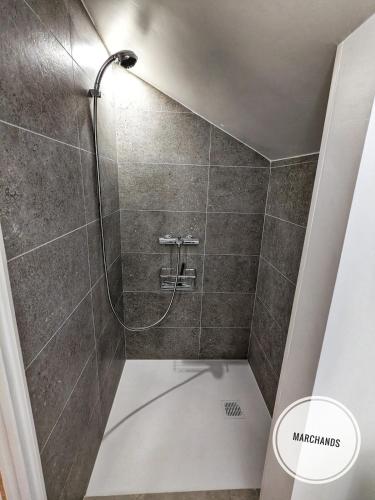 a shower with a glass door in a bathroom at Atypique Souplex Hyper centre Ecusson - Clim - 4p in Nîmes
