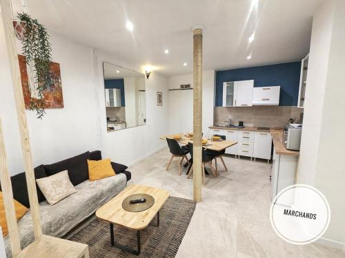 ein Wohnzimmer mit Sofa und Tisch in der Unterkunft Atypique Souplex Hyper centre Ecusson - Clim - 4p in Nîmes