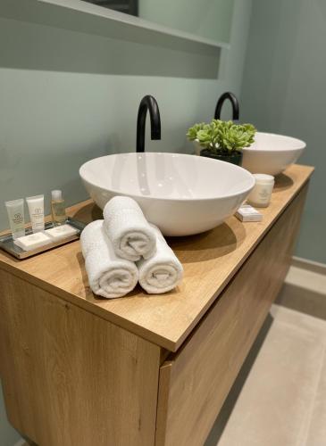 a bathroom counter with a sink and towels on it at Luxury Prinsengracht Canal House Jordan Area in Amsterdam