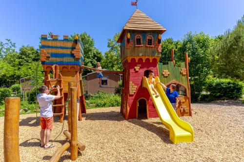 a group of people playing on a playground at Camping Capfun La Bretèche in Les Épesses