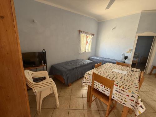 a bedroom with a bed and a table and chairs at A casa do Amor in Vila do Maio