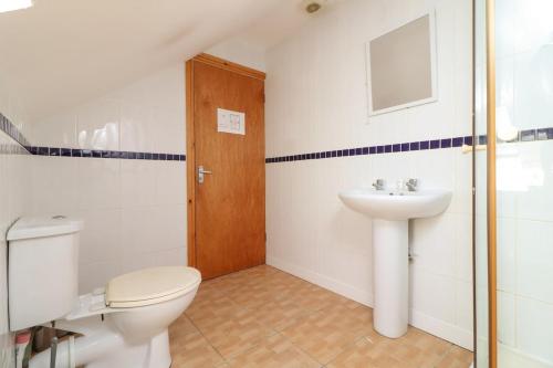 a bathroom with a toilet and a sink at Pebbles Guest House - Flat 5 in Southampton