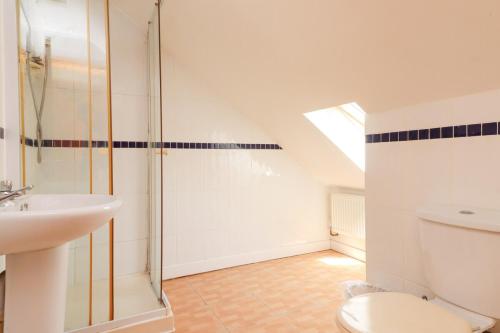 a bathroom with a shower and a toilet and a sink at Pebbles Guest House - Flat 5 in Southampton