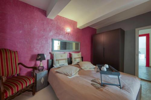 een slaapkamer met 2 bedden, een stoel en een spiegel bij Black & White in Alignan-du-Vent