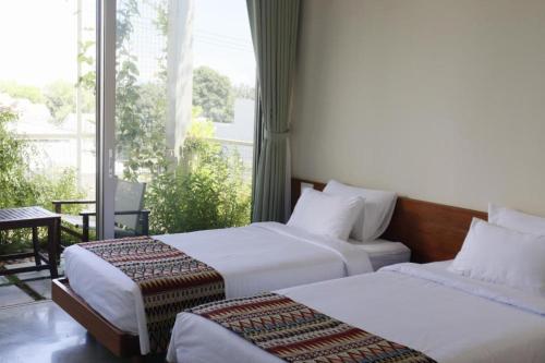 En eller flere senge i et værelse på Marvelous Homestay Hoi An
