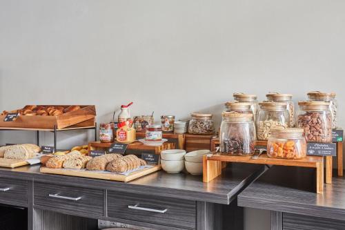 a table with bread and other food items on it at Appart'hôtel Odalys City - Marseille Centre Parc Chanot Vélodrome in Marseille