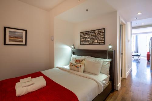 En eller flere senge i et værelse på Les Immeubles Charlevoix - Le 1174