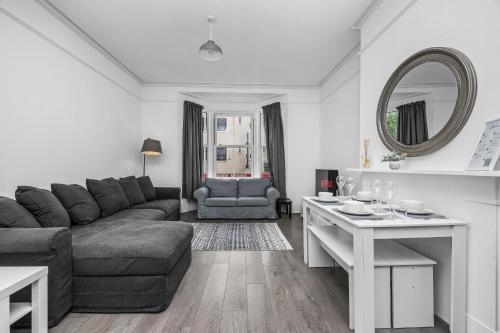 a living room with a couch and a table at Spacious 2 Bed & 1 Bath - Close to Beach & City Centre in Brighton & Hove