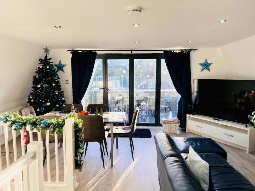 a living room with a christmas tree and a couch at The Barbican Penthouse in Plymouth