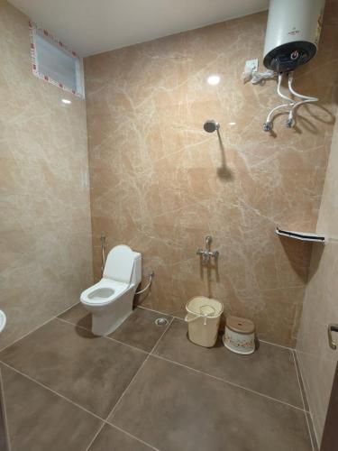 a bathroom with a toilet and a sink and a shower at Zeenus Holiday Resort in Yercaud