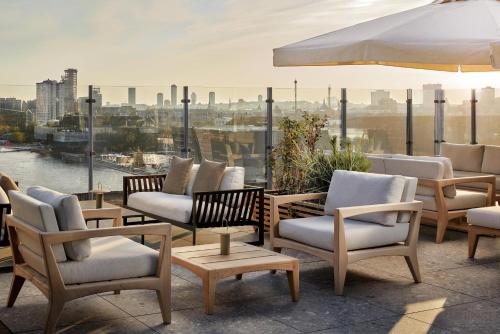 a group of chairs and tables on top of a building at NH Collection Copenhagen in Copenhagen
