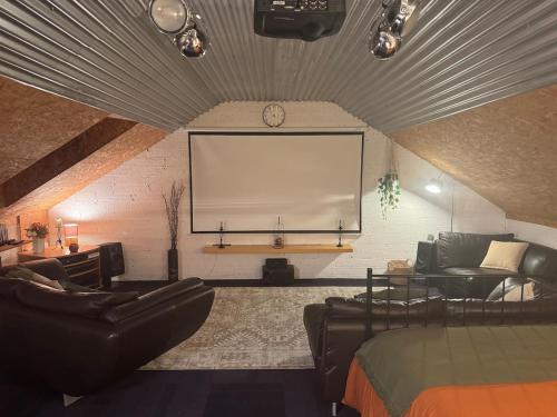 a living room with a large screen in a room at The Loft in Lurgan