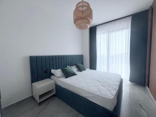 a bedroom with a large bed and a window at Rezidenca Onda in Lezhë