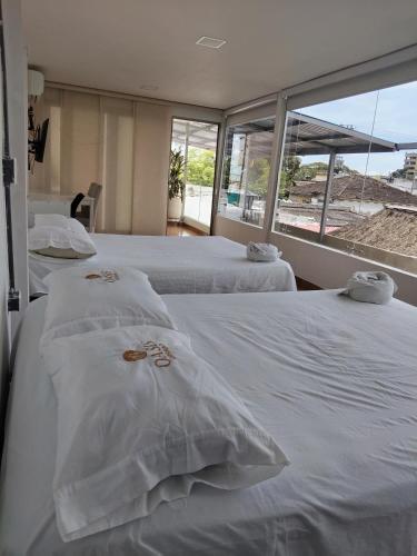 En eller flere senge i et værelse på Oasis Urbano