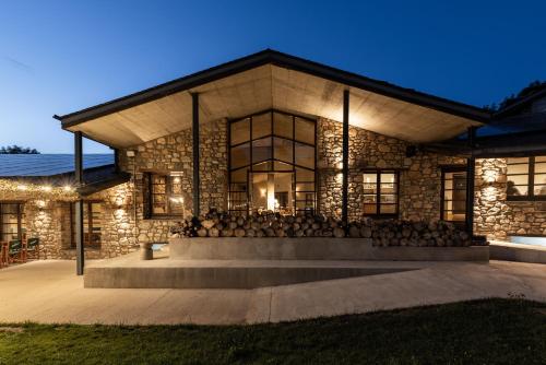 a large stone building with a stage in front at Basecamps Cerdanya in Caixáns