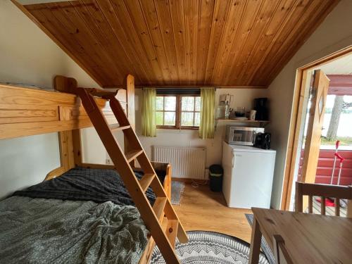 a room with a bunk bed and a kitchen at Våmåbadets Camping in Våmhus