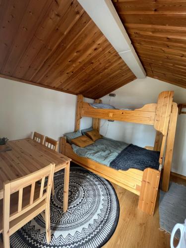 a room with two bunk beds and a table at Våmåbadets Camping in Våmhus