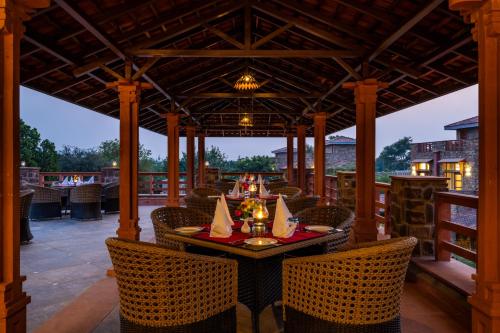 an outdoor dining area with a table and chairs at SeraiBagh Resort in Khilchipur