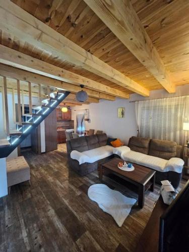 a living room with a couch and a staircase at Village Drago in Cetinje