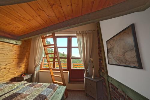 a bedroom with a bed and a window at Apartman 105 Pec pod Sněžkou in Pec pod Sněžkou