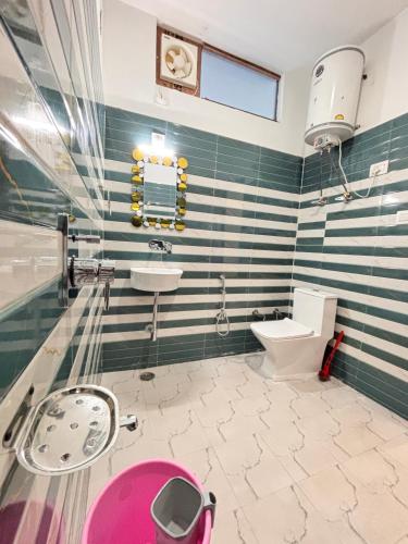a bathroom with a sink and a toilet at Raj Hotel and Restaurant in Bhadarwāh