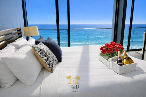 a hotel room with a bed with a view of the ocean at Ocean View Luxury Condo Oceanfront and Pool in San Diego