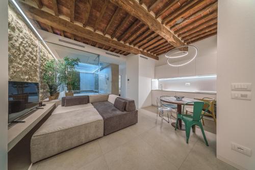 a living room with a large bed and a table at Loft SPA Massa Marittima in Massa Marittima