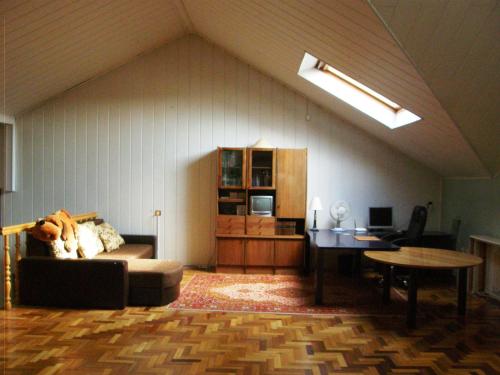 a living room with a couch and a table at Home for Guests Lakštingala in Šiauliai