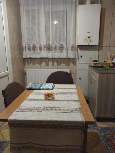 a table with a quilt on it in a kitchen at La Han in Făgăraş