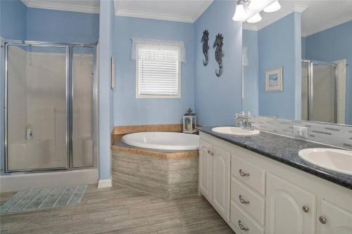 a bathroom with two sinks and a shower at Beachfront Home with Huge Deck in Bolivar Peninsula