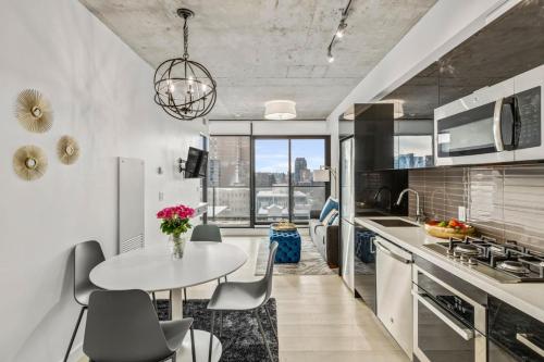 a kitchen with a table and chairs in a room at Spacious and Stylish Modern Condo in Calgary in Calgary