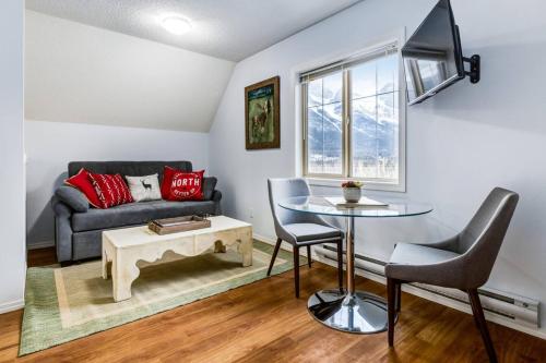 a living room with a couch and a table at Cozy Mountain View Condo Close to DT Canmore in Canmore