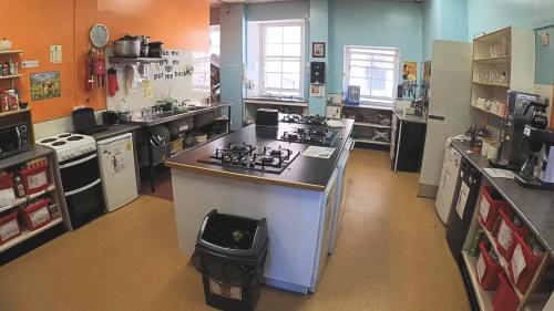 a kitchen with a stove and a counter top at High Street Hostel - Over 18s Only, Backpackers Atmosphere in Edinburgh