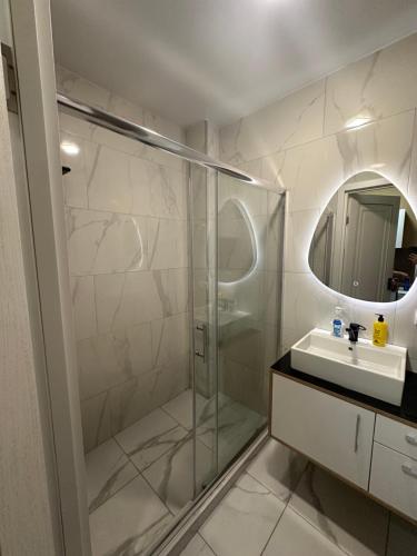 a bathroom with a glass shower and a sink at bamboo beach in Buknari