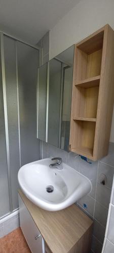 a bathroom with a white sink and a mirror at Ferienhälfte Insel Rügen in Glowe