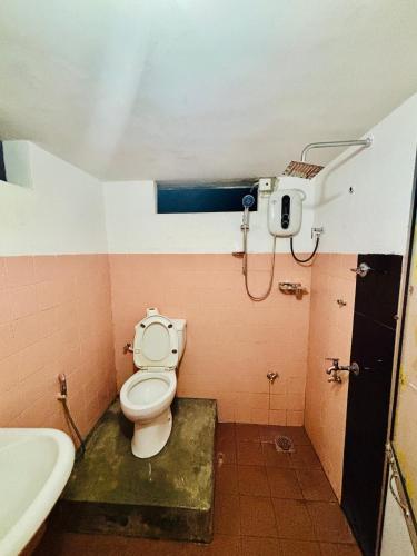a bathroom with a toilet and a sink at 11 11 Weligama in Weligama