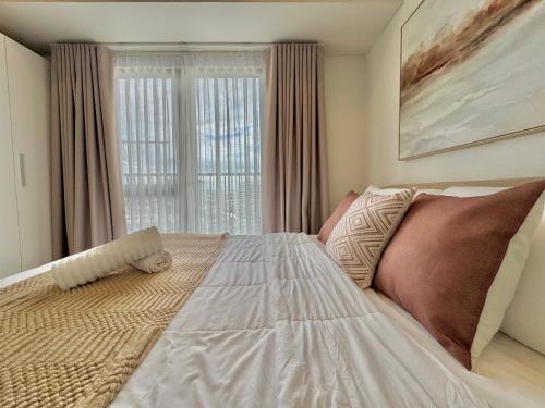 Letto o letti in una camera di Chic Units at Ivory Residences