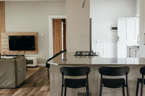 a kitchen with a large island in the middle of a room at Disa Close 3 Cathkin Estates in Winterton