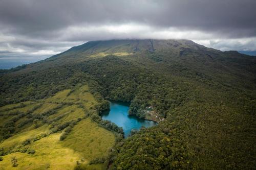 an aerial view of a mountain with a blue lake at Asha Hostel in Fortuna