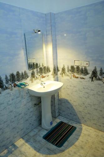 a white sink in front of a window with a beach at Urban Tide Dickwella in Batigama