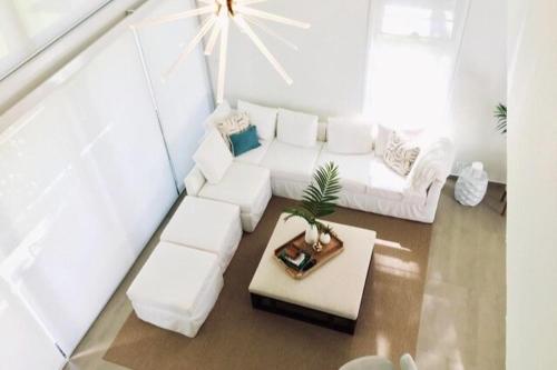 a living room with a white couch and a table at Stella w Pool Dorado Beach Resort 4BR in Mameyal