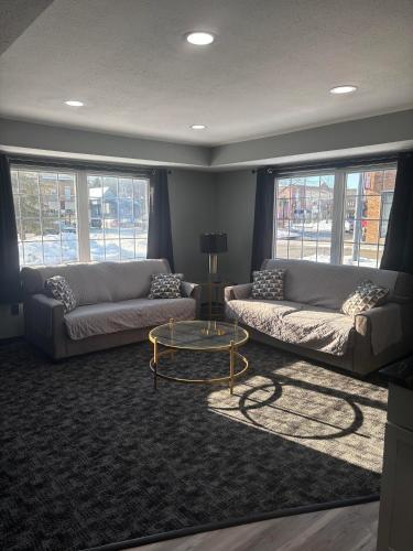 a living room with two couches and a coffee table at Plymouth Suites in Plymouth