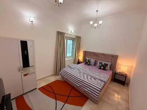 a bedroom with a bed and a window at Gorgeous Villa Rooms opposite to Mirdif City Center in Dubai